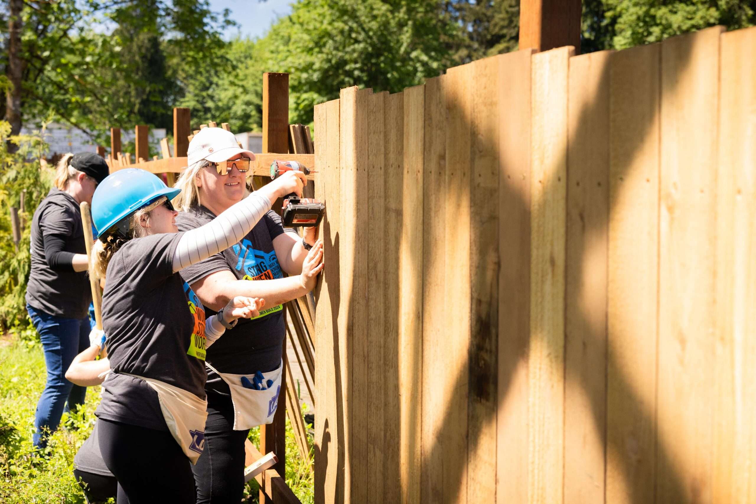 Volunteers build a fence.